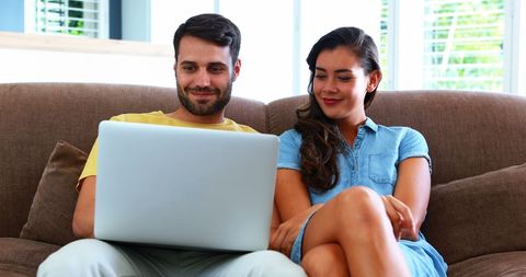 Happy Couple Browsing on Laptop in Home Living Room - Download Free Stock Images Pikwizard.com
