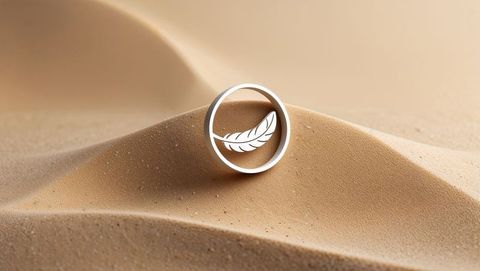 Abstract feather emblem hovering over desert dunes
