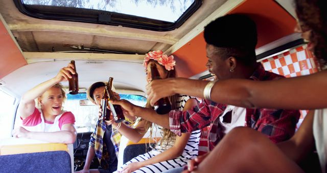 Group of friends enjoying drinks and toasting inside a camper van during a road trip. Perfect for themes around friendship, travel, celebration, summer fun, and outdoor activities. Ideal for promoting adventure tourism, youth travel experiences, and summer vacation ads.