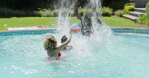 Family Enjoying Summer Fun in Swimming Pool with Beach Ball