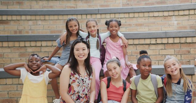 Diverse Schoolgirls with Teacher Smiling in School Hall - Download Free Stock Images Pikwizard.com