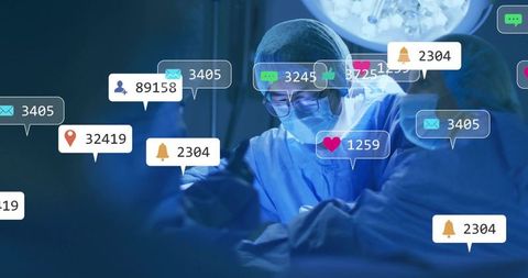 Operating surgeon focusing on delicate surgical procedure with digital notification overlays