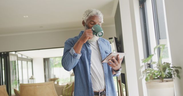 Mature Man Drinking Coffee and Using Tablet at Home - Download Free Stock Images Pikwizard.com