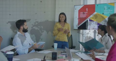 Female Leader Presenting Data in Modern Office Setting