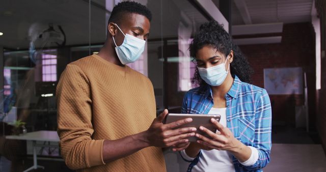 Coworkers Collaborating on Digital Tablet in Modern Office with Face Masks - Download Free Stock Images Pikwizard.com