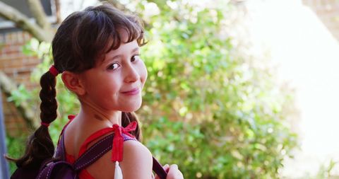 Cheerful Schoolgirl Grinning Outdoors with Backpack - Download Free Stock Images Pikwizard.com