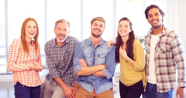 Diverse team of smiling colleagues posing together at office - Download Free Stock Images Pikwizard.com