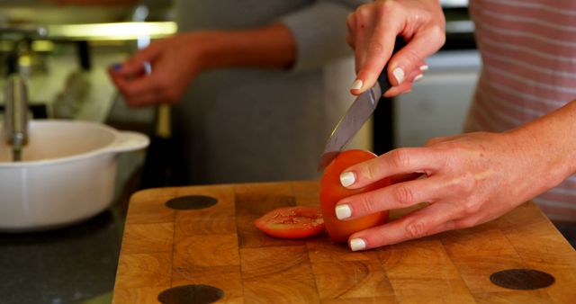 Midsection of caucasian lesbian couple cutting tomatoes preparing breakfast in kitchen, copy space - Download Free Stock Photos Pikwizard.com