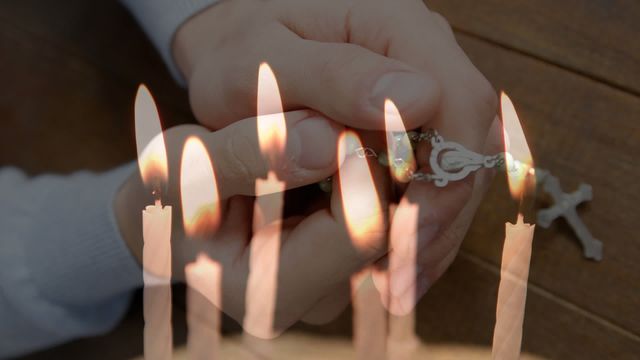 Composite video suggesting religious contemplation. Hands holding a rosary and candles being blown out signifies prayer and spiritual devotion in Christian worship. Suitable for use in religious publications, faith-based blogs, or spiritual reflection projects.