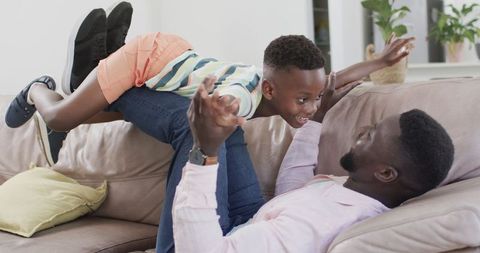 Joyful Father and Son Bonding in Living Room - Download Free Stock Images Pikwizard.com