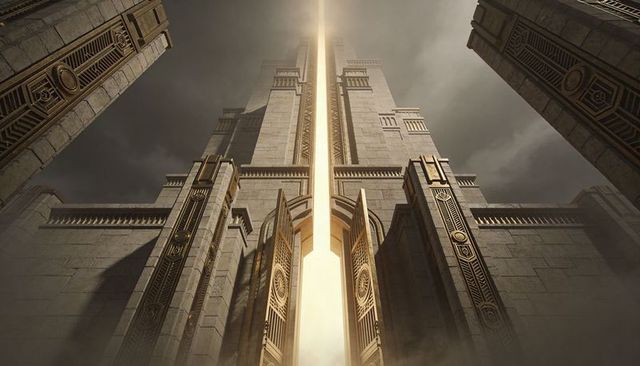 Golden portal tower emitting vertical beam over monumental stone gateway and ornate doors