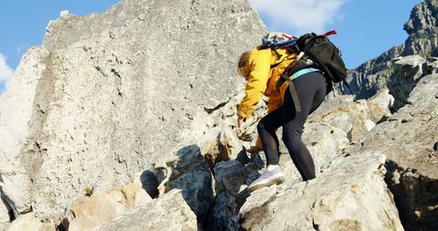 Caucasian Woman Climbing Rocky Mountain Under Blue Sky - Download Free Stock Images Pikwizard.com