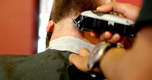 Caucasian man getting a haircut at a barbershop. Precision is key as the barber ensures a clean and stylish trim for their client.
