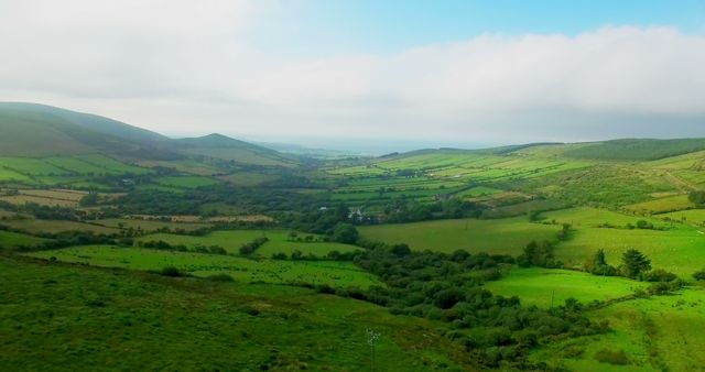 Green patchwork fields on the hills 4k