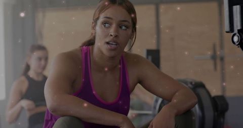 Diverse Women in Gym Reflecting Intensity of Workout