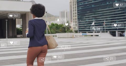 Businesswoman Walking in Urban Area with Social Media Notifications
