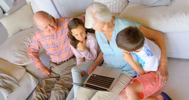 Grandparents Sharing Stories with Grandchildren Using Laptop - Download Free Stock Images Pikwizard.com