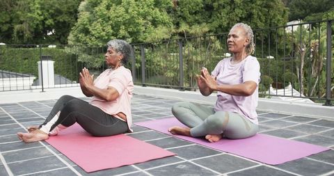 Senior Women Practicing Yoga on Balcony