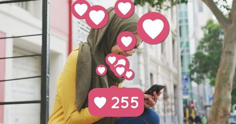 Woman in Hijab Enjoying Social Media Engagement Outdoors - Download Free Stock Images Pikwizard.com