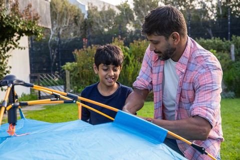Father and Son Building Tent in Backyard Outdoors