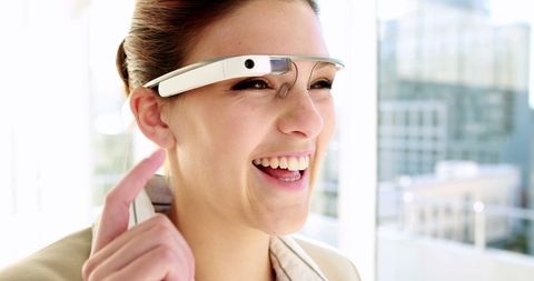 Businesswoman using smart glasses in modern office environment