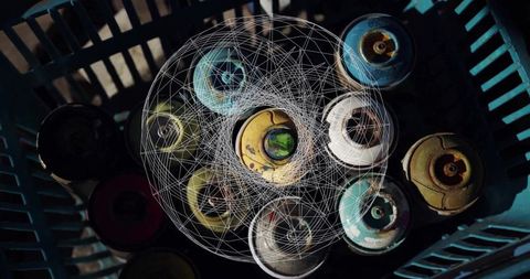 Top view of spray paint cans with digital wireframe overlay