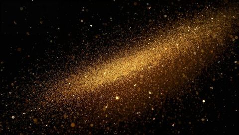 Shimmering Gold Dust Cloud Drifting Across Black Backdrop with Metallic Glitter Trail