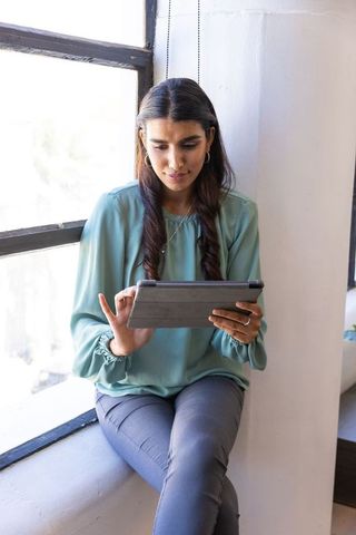 Businesswoman using tablet in modern workspace