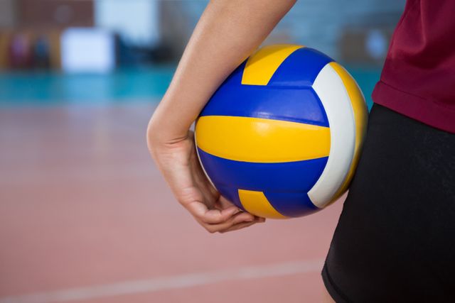 Close-up of Female Volleyball Player Holding Ball in Court - Download Free Stock Photos Pikwizard.com