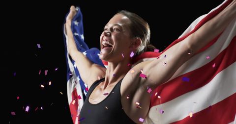 Ecstatic Female Athlete Celebrating with American Flag and Confetti