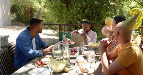 Birthday celebration in sunny garden with friends