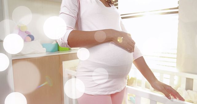 Pregnant Woman with Bokeh Light Effects in Nursery - Download Free Stock Images Pikwizard.com