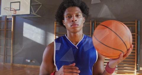 Confident Basketball Player Ready on Indoor Court with Ball