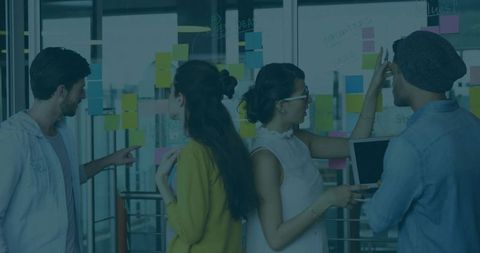 Creative Team Collaborating in Modern Office with Sticky Notes