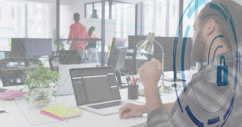 Bearded developer coding on laptop in open office with security overlay and copy space