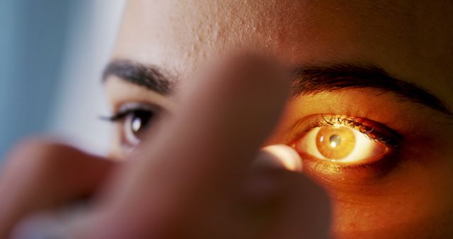Close-up view highlighting optometrist examining patient's eye with bright light. Useful for healthcare, optometry clinics, vision care presentations, and educational materials on eye health and examinations.