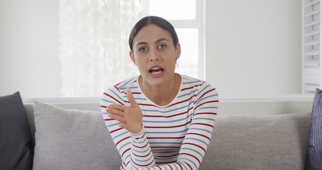 Confident Young Woman Explaining Her Point on Sofa - Download Free Stock Images Pikwizard.com