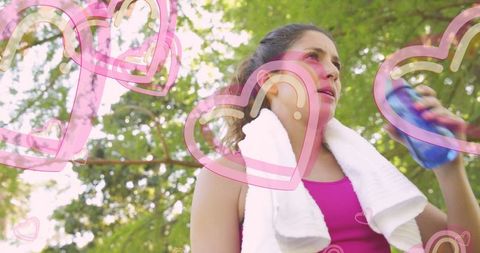 Woman Exercising in Park with Creative Pink Heart Graphics