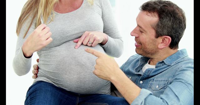 Happy Couple Expecting Baby Joyfully Bonding Together - Download Free Stock Images Pikwizard.com