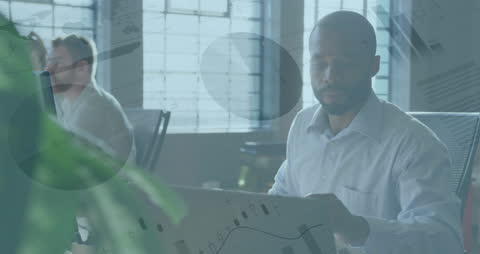 African American Professional Analyzing Data on Laptop in Modern Office
