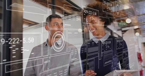 Business professionals analyzing augmented reality data overlays in modern office corridor