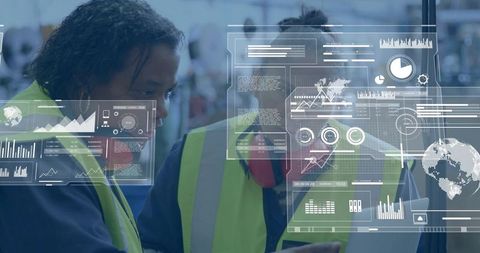 Two warehouse workers reviewing tablet with augmented reality dashboard and analytics