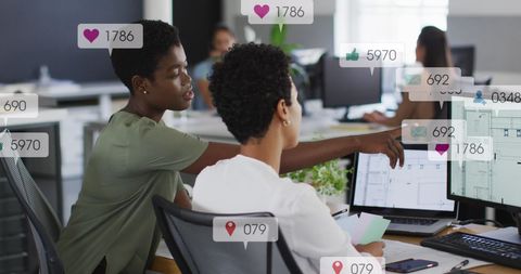 Colleagues Discussing Social Media Strategy with Interactive Notifications