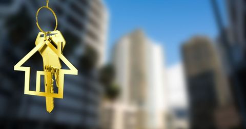 Golden House Keys Dangling Against Blurred Tall Buildings - Download Free Stock Images Pikwizard.com