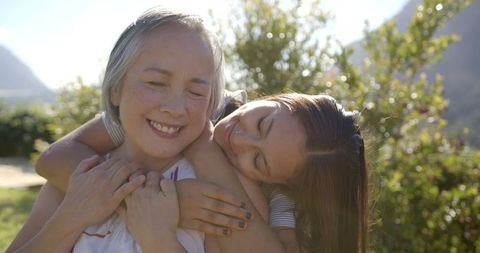 Grandmother and Granddaughter Sharing Loving Embrace Outdoors