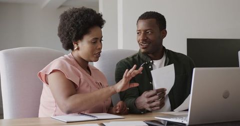 Collaborative discussion on project by friends at home workspace