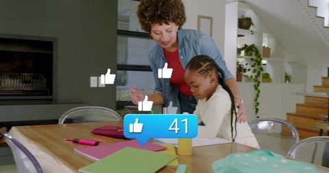 Helping child with homework at home table while social likes counter showing 41