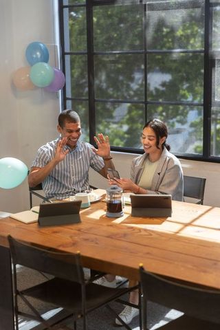 Diverse Colleagues in Lively Meeting Room Sharing Ideas