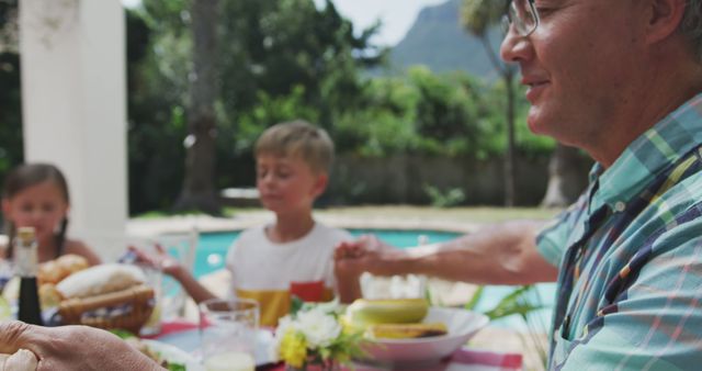 Multi-generational Family Enjoying Meal by the Pool in Summer - Download Free Stock Photos Pikwizard.com