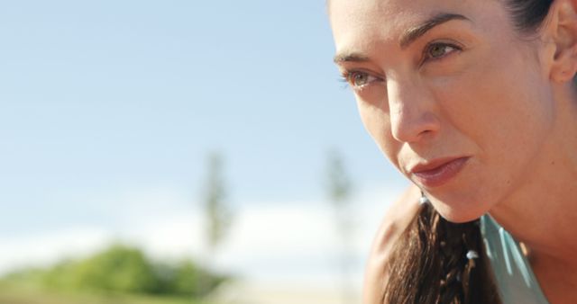 Focused Woman Preparing for Outdoor Workout on Sunny Day - Download Free Stock Images Pikwizard.com